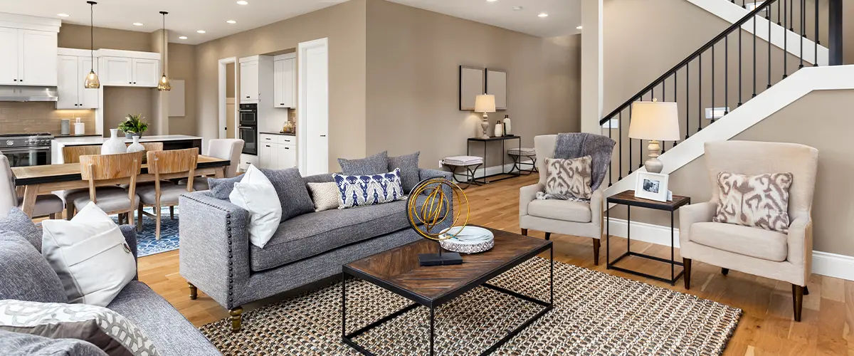 Modern open-concept living and dining area with neutral tones, wood floors, and contemporary furnishings.